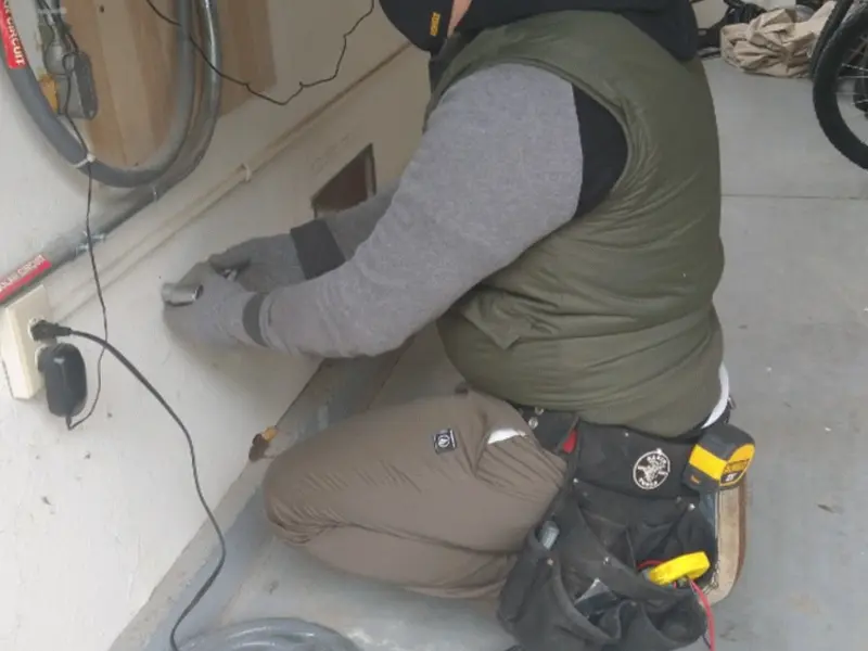 Electrician performing outlet wiring in a Shoreview garage