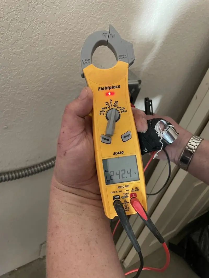 Voltage testing with clamp meter during Outlet Installation in Shoreview
